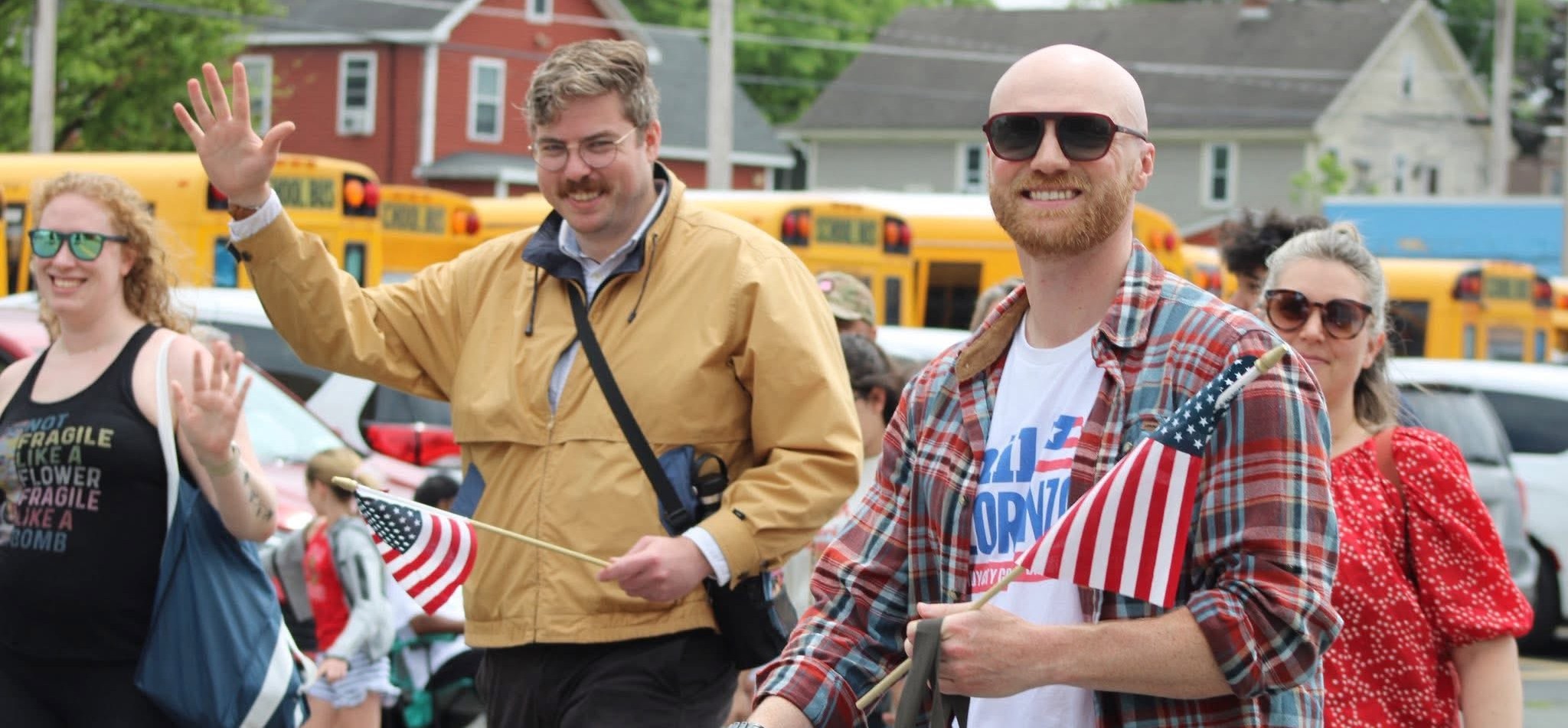 Troy Democrats marching in a parade, waving American flags
